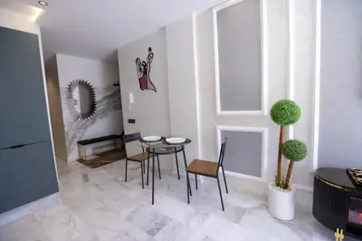a small dining room with a table and chairs at Luxe Ghandi Casablanca in Casablanca