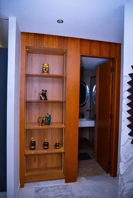 a room with a wooden book shelf with cups on it at Luxe Ghandi Casablanca in Casablanca