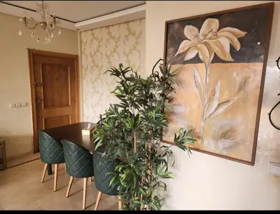 a dining room with a table and some plants at Palerme in Mohammedia