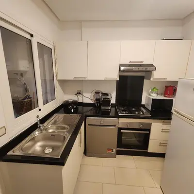 a small kitchen with a sink and a stove at Diana Ennour in Rabat