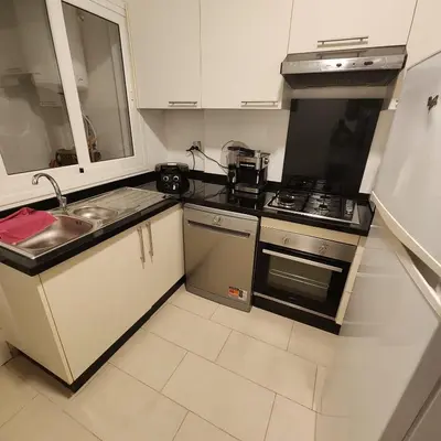 a kitchen with a sink and a stove top oven at Diana Ennour in Rabat