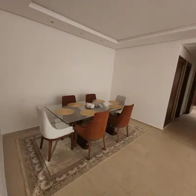 a dining room table and chairs in a room at Diana Ennour in Rabat