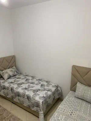 a bedroom with a bed and a couch at Appartement à Skhirat in Skhirat