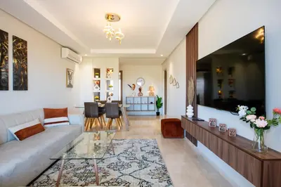 a living room with a couch and a table at Chic, bright, 2 BR apartment, panoramic view & Parking in Temara