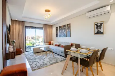 a living room with a table and a couch at Chic, bright, 2 BR apartment, panoramic view & Parking in Temara