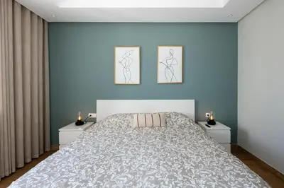 a bedroom with a large bed with two night stands at Chic, bright, 2 BR apartment, panoramic view & Parking in Temara
