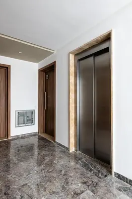 an empty lobby with doors and marble floors at Chic, bright, 2 BR apartment, panoramic view & Parking in Temara
