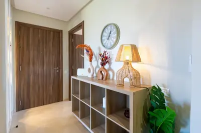 a room with a table with a lamp and a clock at Chic, bright, 2 BR apartment, panoramic view & Parking in Temara