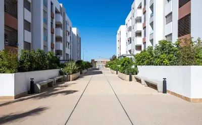 an empty sidewalk in a building with buildings at Chic, bright, 2 BR apartment, panoramic view & Parking in Temara