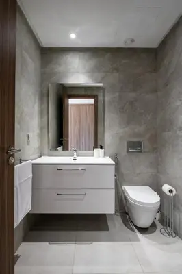 a bathroom with a sink and a toilet and a mirror at Chic, bright, 2 BR apartment, panoramic view in Temara