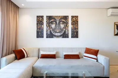 a living room with a couch and a painting at Chic, bright, 2 BR apartment, panoramic view in Temara