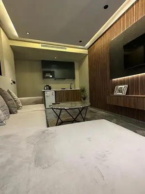 a living room with two beds and a table at Joli appartement a casablanca in Casablanca