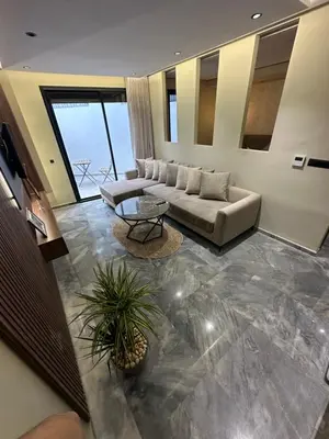 a living room with a couch and a table at Joli appartement a casablanca in Casablanca