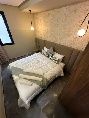 a bedroom with a large bed with white sheets and pillows at Joli appartement a casablanca in Casablanca
