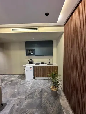 a kitchen with a white refrigerator and a counter at Joli appartement a casablanca in Casablanca