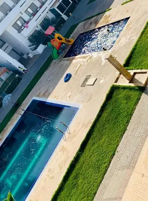 an overhead view of a swimming pool with grass at Elegant & spacious with a view in Mansouria