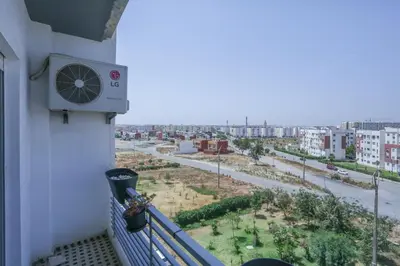 a balcony with a view of a city at Terrasse au Soleil, Confort in Bouskoura