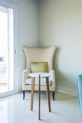 a chair with a pillow on a table in a room at Terrasse au Soleil, Confort in Bouskoura