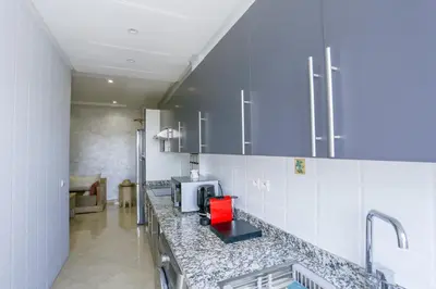 a kitchen with a counter top with a microwave at Terrasse au Soleil, Confort in Bouskoura