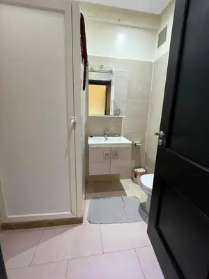 a bathroom with a white toilet and a sink at Superbe appartement en résidence avec piscine in Mohammedia