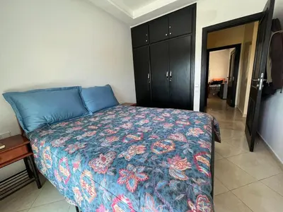 a bedroom with a bed with a colorful bedspread at Superbe appartement en résidence avec piscine in Mohammedia