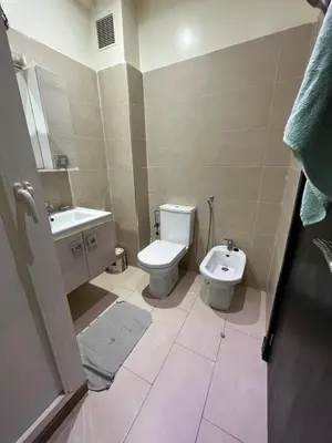a bathroom with a toilet and a sink at Superbe appartement en résidence avec piscine in Mohammedia