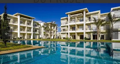 a swimming pool in front of a building at Casabay T4 Sidi Rahal Vacation apartment in Sidi Rahal