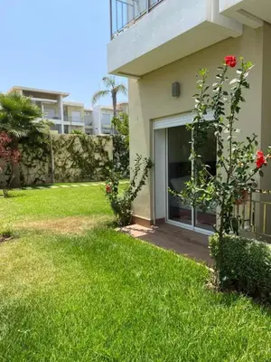 a house with a yard with a garage at Casabay T4 Sidi Rahal Vacation apartment in Sidi Rahal