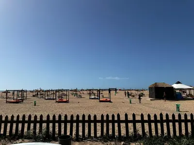 a playground on a beach with a fence at Casabay T4 Sidi Rahal Vacation apartment in Sidi Rahal