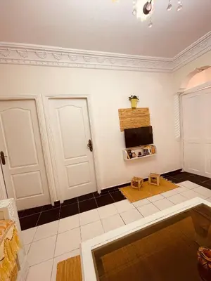 a living room with white walls and black and white tiles at Attractive Studio in Casablanca in Casablanca