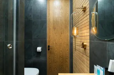 a bathroom with a toilet and a sink and a mirror at charcho place in Les Camps