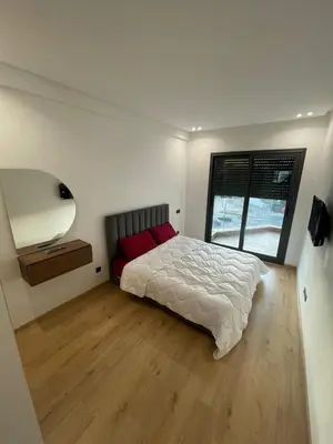 a bedroom with a large bed and a window at Casawi in Casablanca