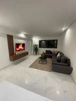 a living room with a couch and a fireplace at Casawi in Casablanca