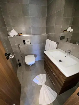 a bathroom with a sink and a toilet at Natura Appartement Pool View by 7AV Hotels in Mohammedia