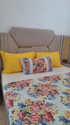 a bed with colorful pillows on top of it at Suites au sein d'une Villa au centre ville de Rabat in Rabat