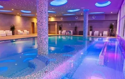 a large swimming pool in a hotel with purple lights at Studio Seaside Resort Casablanca in Dar Hamida