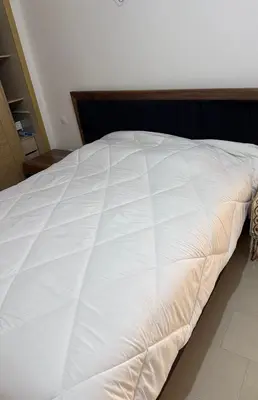 a large white bed sitting in a bedroom at Studio Seaside Resort Casablanca in Dar Hamida