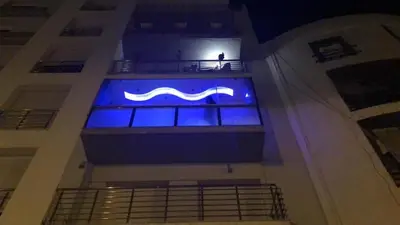 a blue sign on the side of a building at Appartement Prestige à Rabat Océan - 2min de la Plage in Rabat