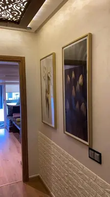 two framed pictures on a wall in a room at Appartement Prestige à Rabat Océan - 2min de la Plage in Rabat