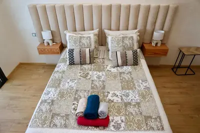 a bedroom with a large bed with pillows at Zen garden by sea in Aïn Harrouda
