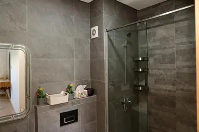 a shower with a glass door in a bathroom at Zen garden by sea in Aïn Harrouda