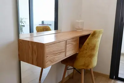a wooden desk with two chairs and a mirror at Zen garden by sea in Aïn Harrouda