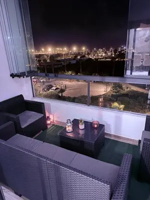 a room with a view of a city at night at Zen garden by sea in Aïn Harrouda