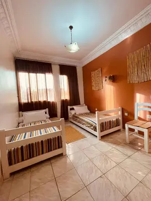 a living room with two beds and a table at Beautiful Studio in Casablanca in Casablanca