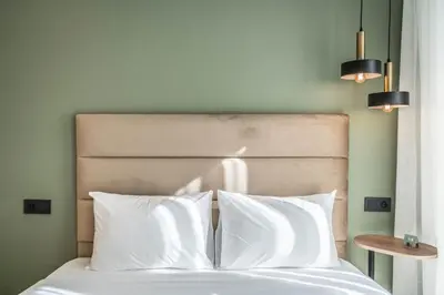 a bed with white sheets and pillows in a bedroom at Studio palmier TR3 in Casablanca