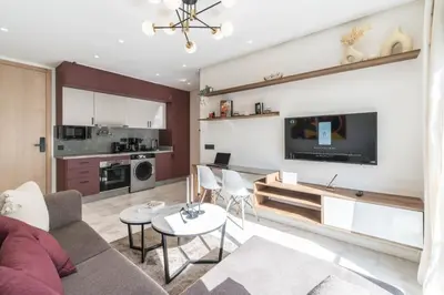a living room with a couch and a tv at Studio palmier TR3 in Casablanca