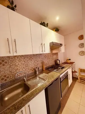 a kitchen with white cabinets and a sink at Havre de Paix in Casablanca in Casablanca