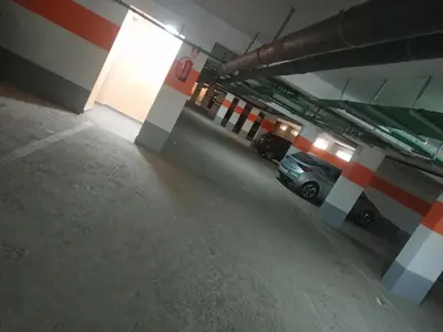 an empty parking garage with a car parked in it at Casa sabir in Temara