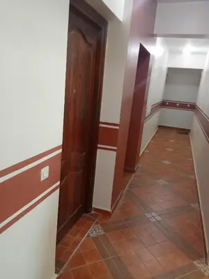 a hallway with a door and a tile floor at Casa sabir in Temara