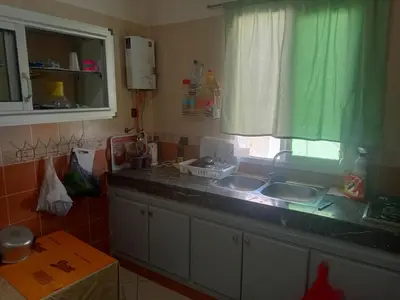 a kitchen counter with two sinks and a window at Casa sabir in Temara